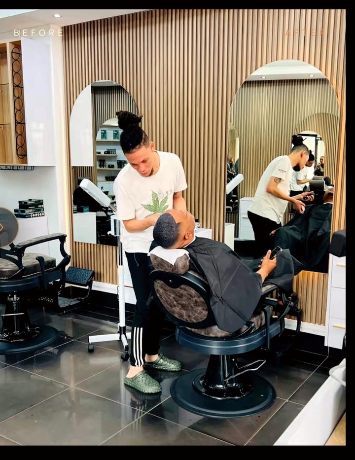 Inside The Exclusive Hair Studio — barber attending to a client between arched mirrors and warm timber slat walls in Umhlanga