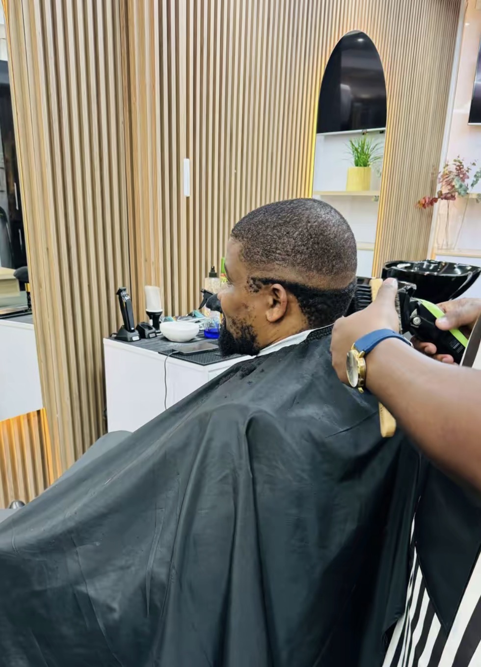 Client mid-service in the barber chair — precision line-up in progress